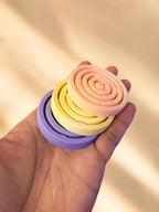 Stack of pastel air spinners held in one hand